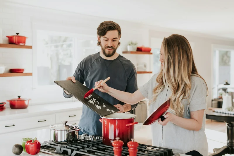Two people cooking together in a kitchen