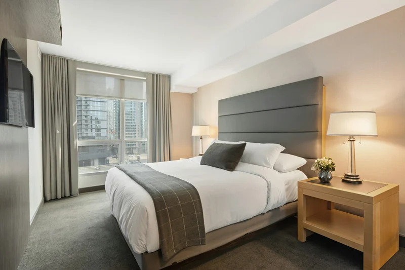A neatly made bed in a modern bedroom